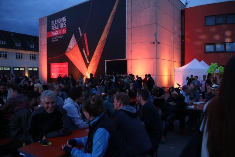 Crowd gathered at the Filmakademie Baden-Württemberg event, with a large banner in the 
background reading "Blending Realities FMX 2016"